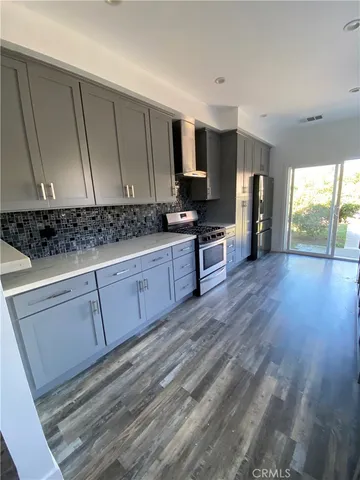 a view of a kitchen with wooden floor