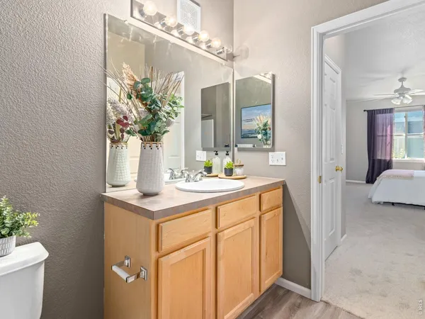 a bathroom with a sink a toilet and a mirror