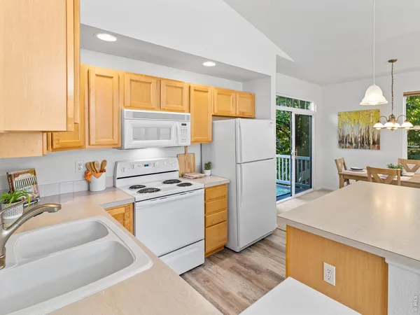 a kitchen with wooden cabinets and a refrigerator
