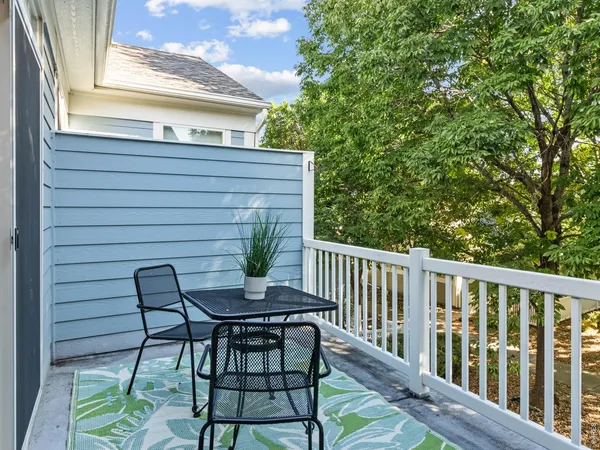 a view of balcony with wooden floor and outdoor seating