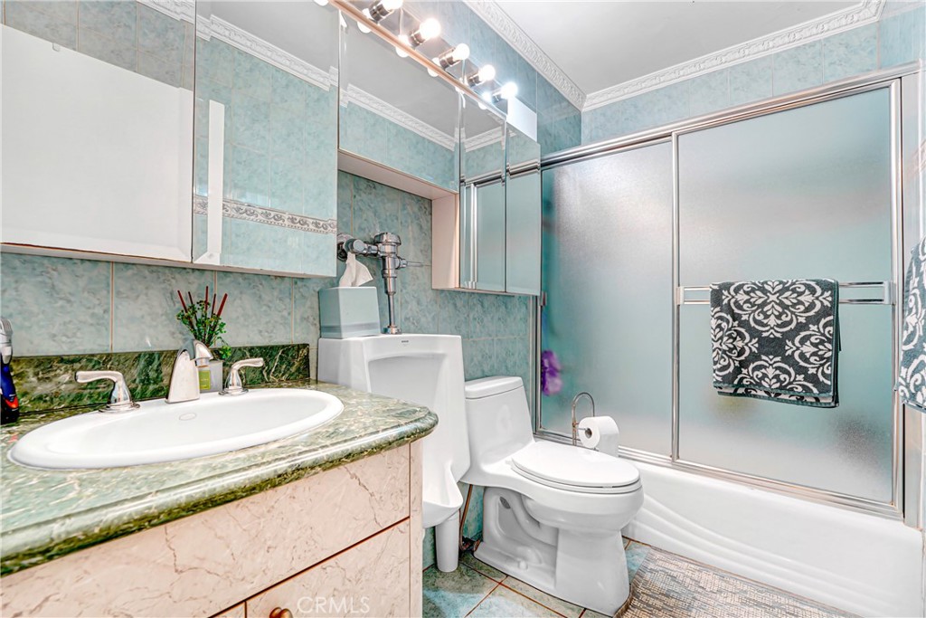 4313 Rhodes Avenue Studio City, CA 91604 - Photo 14 of 23 a bathroom with a granite countertop sink mirror vanity and toilet