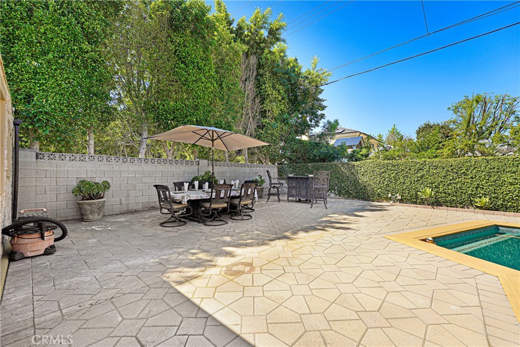 4313 Rhodes Avenue Studio City, CA 91604 - Photo 16 of 23 a view of a patio with a table and chairs under an umbrella