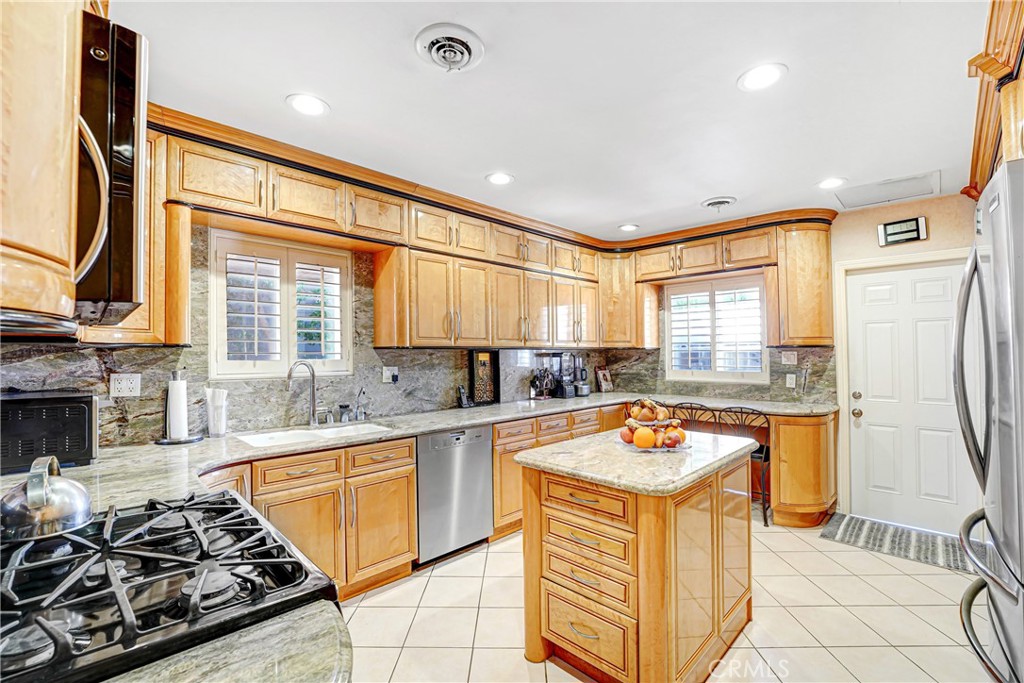 4313 Rhodes Avenue Studio City, CA 91604 - Photo 6 of 23 a kitchen with stainless steel appliances granite countertop a sink stove and refrigerator