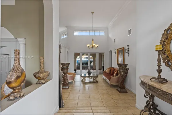 a living room with furniture and a chandelier