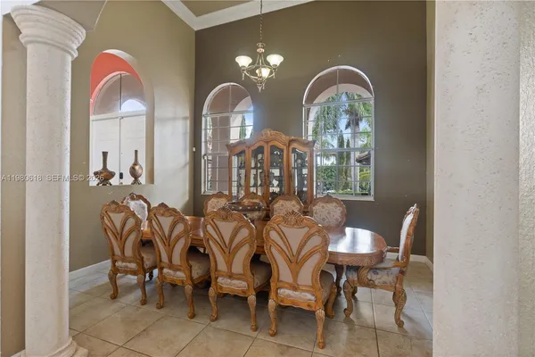 a living room with furniture a window and a chandelier