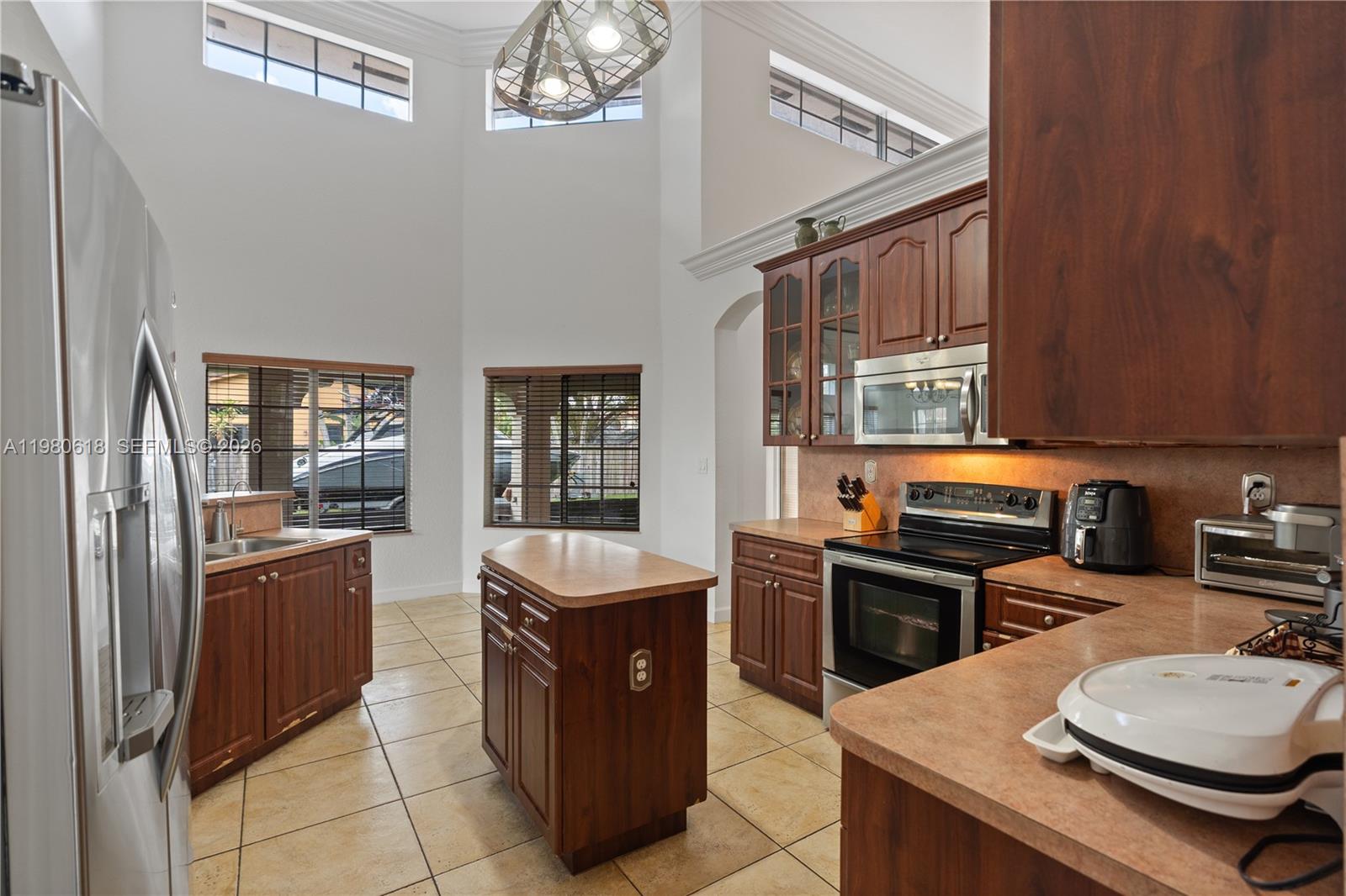 12981 Southwest 197th Street Miami, FL 33177 - Photo 15 of 75 a kitchen with stainless steel appliances granite countertop a sink stove and refrigerator