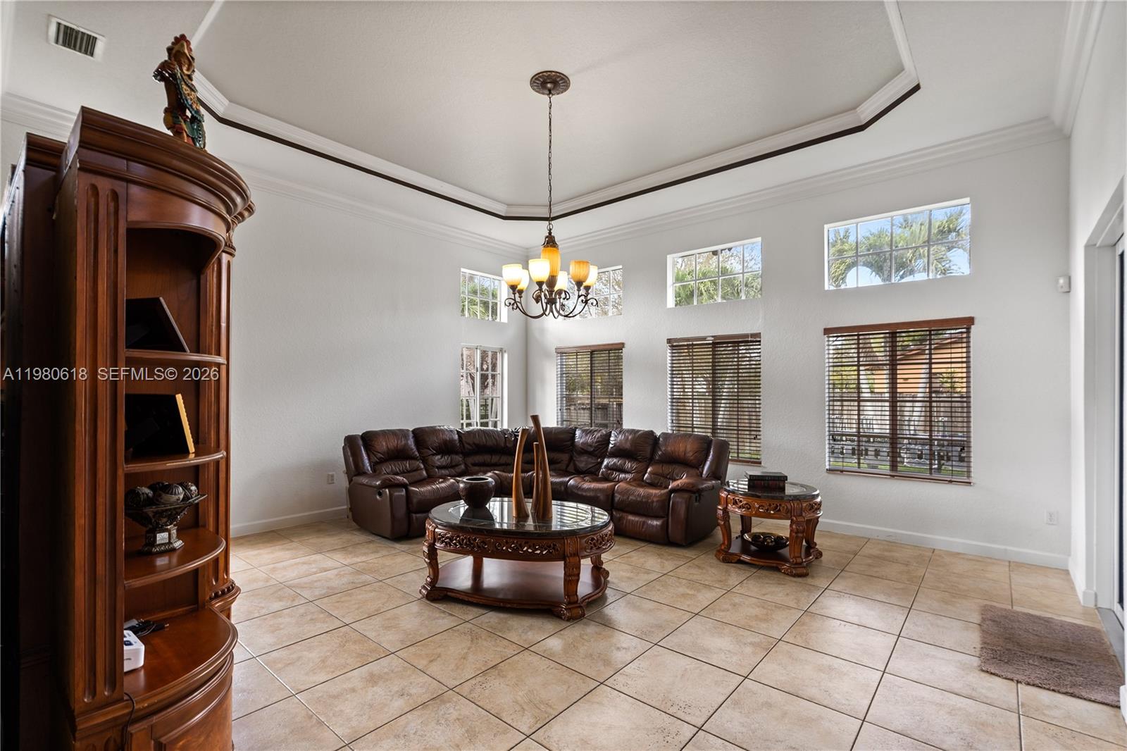 12981 Southwest 197th Street Miami, FL 33177 - Photo 17 of 75 a living room with furniture a window and a chandelier