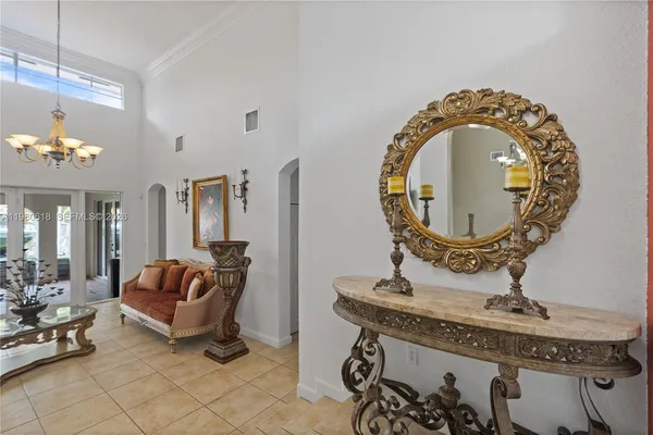 a view of a dining room with furniture and chandelier