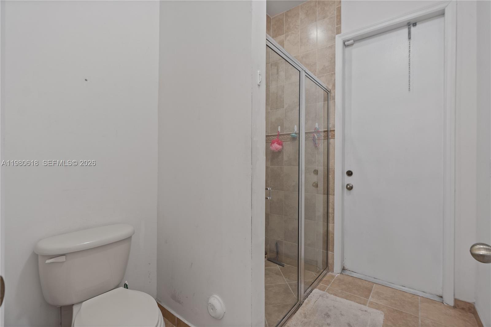 12981 Southwest 197th Street Miami, FL 33177 - Photo 25 of 75 a bathroom with a toilet and a shower