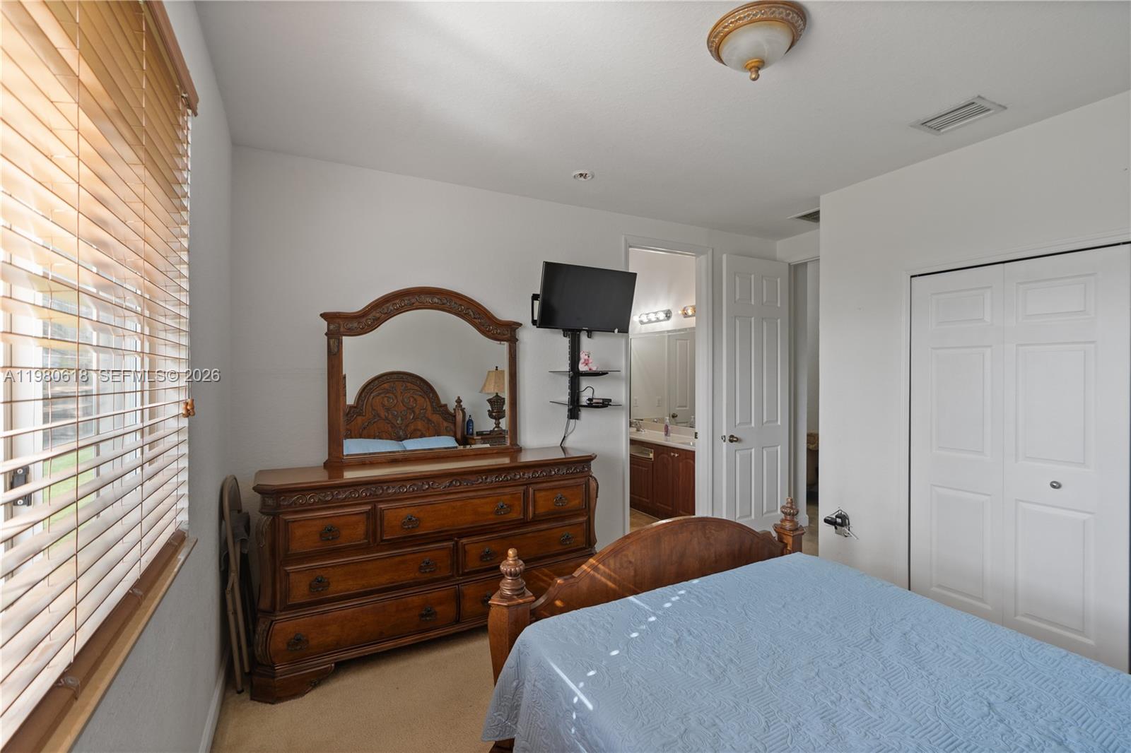 12981 Southwest 197th Street Miami, FL 33177 - Photo 29 of 75 a bedroom with a bed and a dresser
