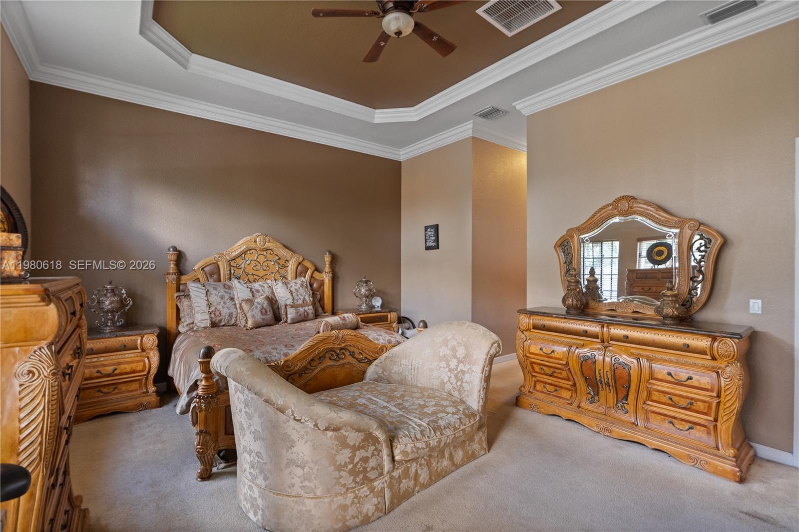 12981 Southwest 197th Street Miami, FL 33177 - Photo 35 of 75 a bedroom with a bed and a chandelier