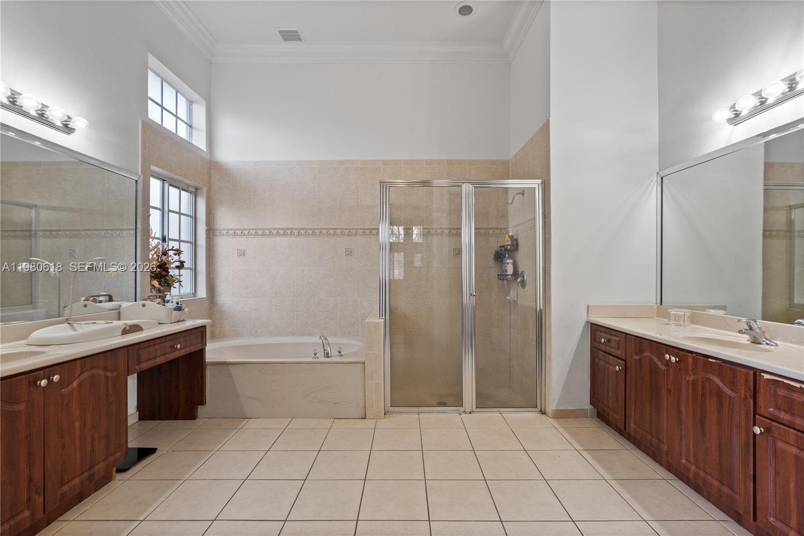 12981 Southwest 197th Street Miami, FL 33177 - Photo 39 of 75 a spacious bathroom with a granite countertop sink a toilet a mirror and shower