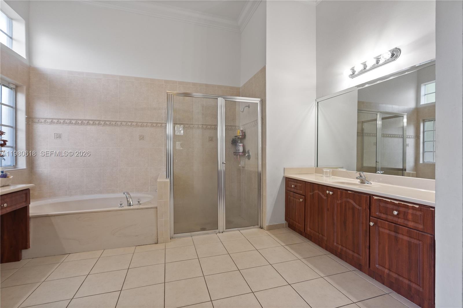 12981 Southwest 197th Street Miami, FL 33177 - Photo 40 of 75 a spacious bathroom with a tub sink shower and mirror
