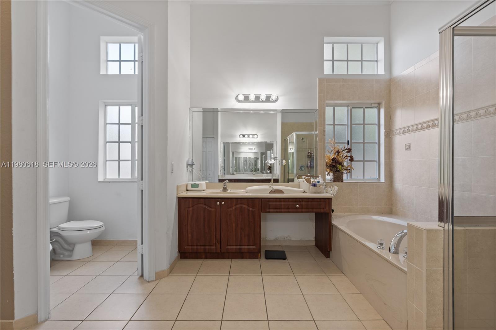12981 Southwest 197th Street Miami, FL 33177 - Photo 42 of 75 a bathroom with a bathtub shower sink vanity and toilet