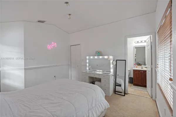 an aerial view of a house with a garden and lake view