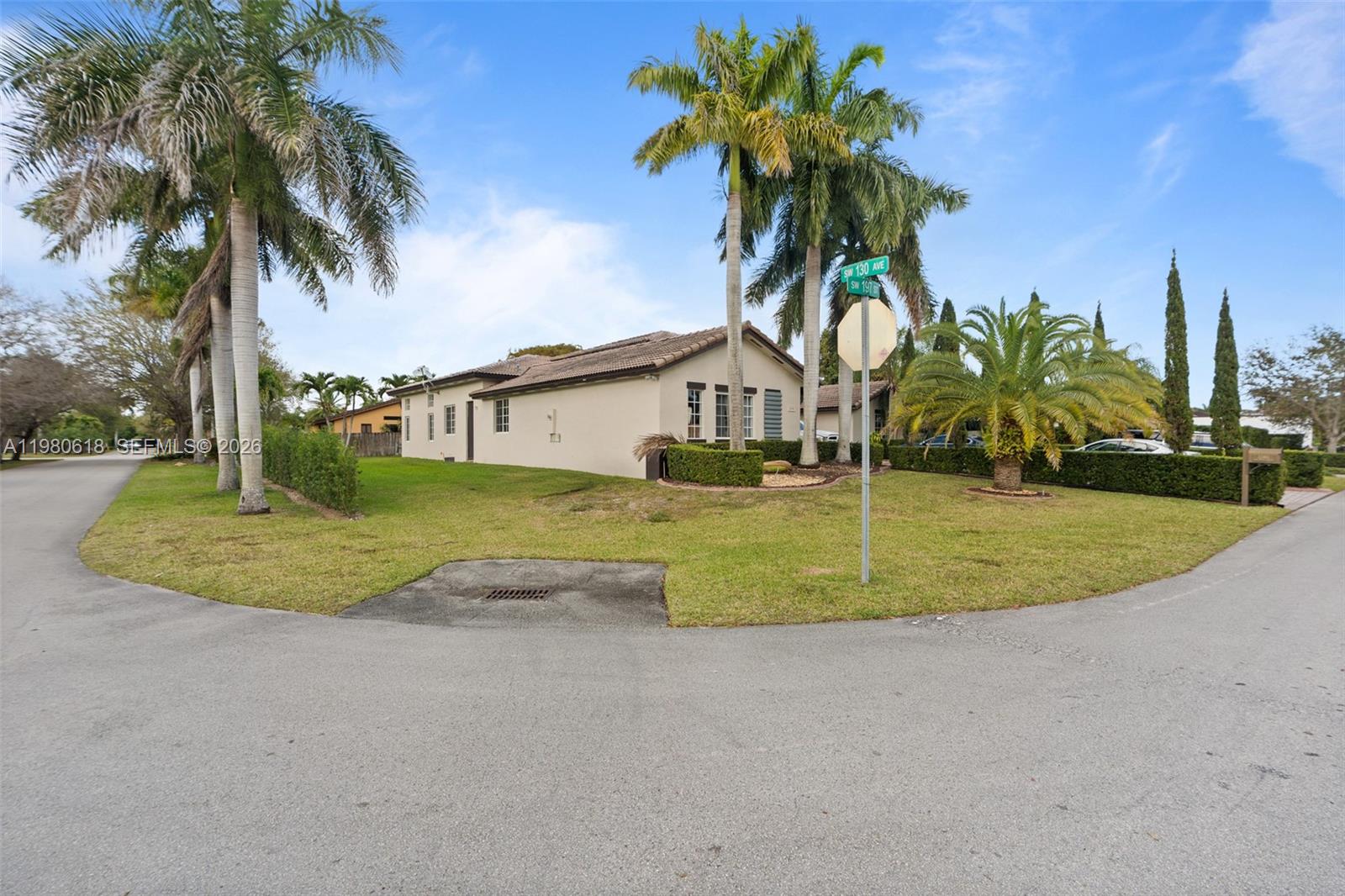 12981 Southwest 197th Street Miami, FL 33177 - Photo 62 of 75 a view of a house with a yard and palm trees