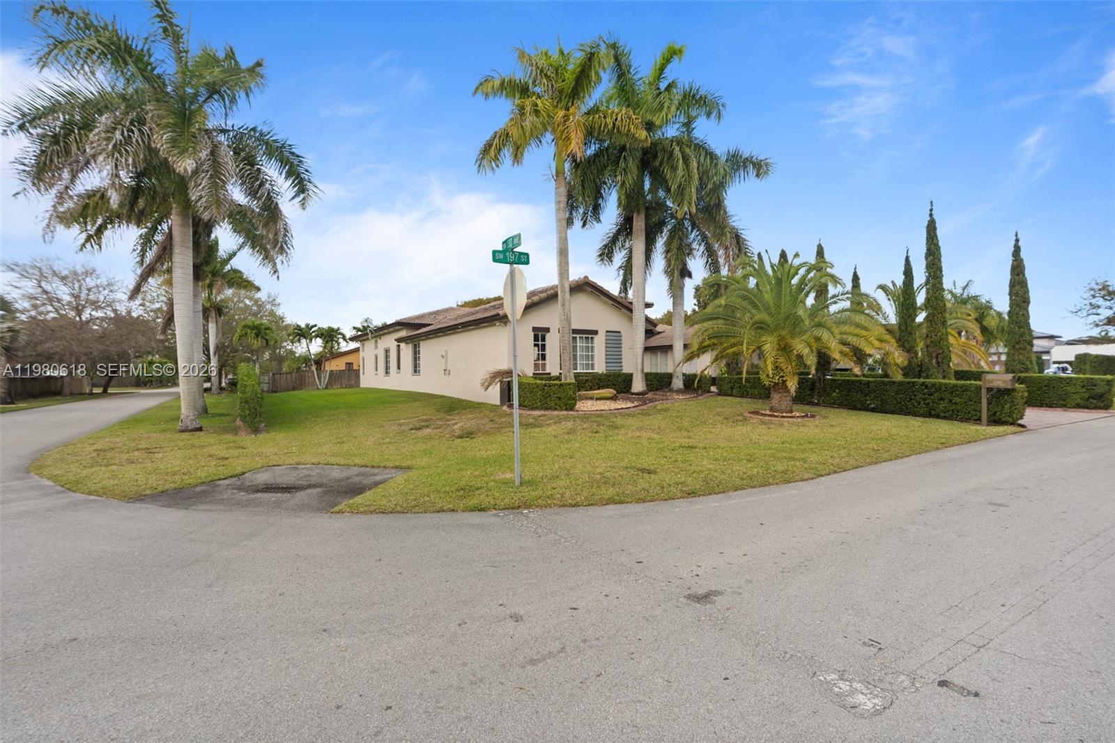 12981 Southwest 197th Street Miami, FL 33177 - Photo 63 of 75 a view of a house with a yard and palm trees