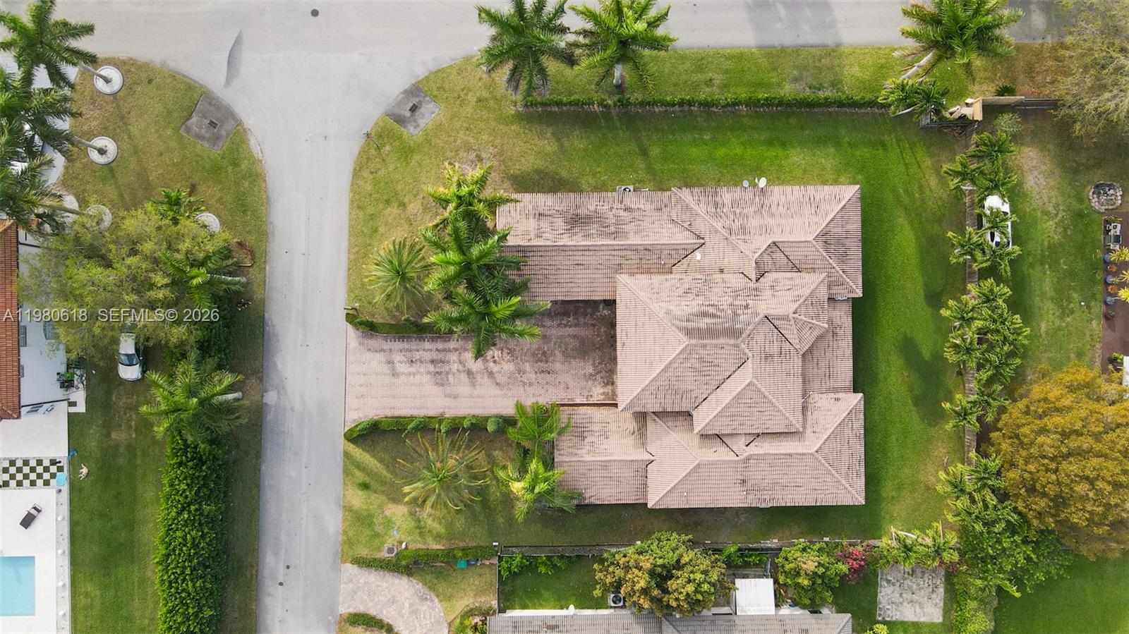 12981 Southwest 197th Street Miami, FL 33177 - Photo 75 of 75 an aerial view of a house with a garden and lake view