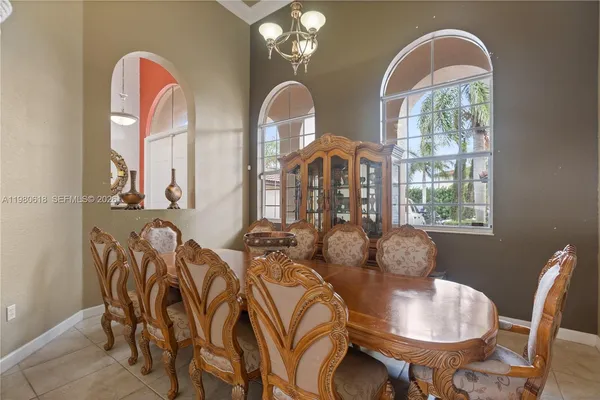 a kitchen with kitchen island a counter top space a refrigerator cabinets and stainless steel appliances