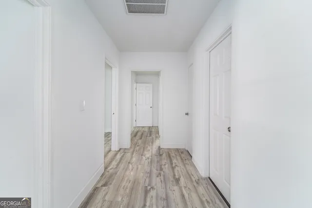 a view of a room with wooden floor
