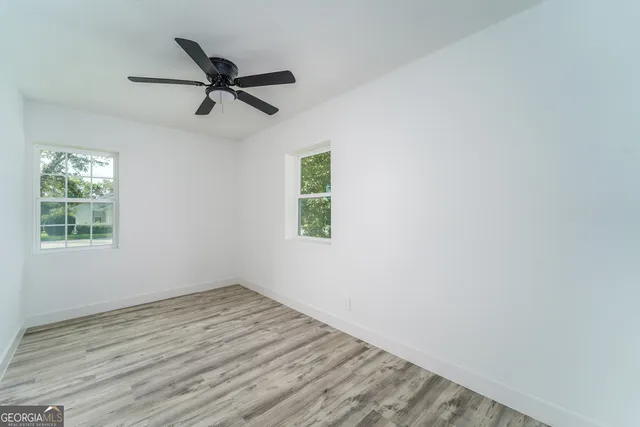 wooden floor in an empty room with a window