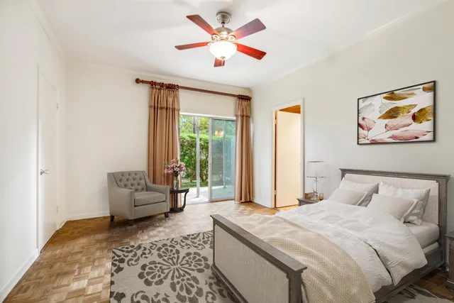 a bedroom with a large bed couch and a window