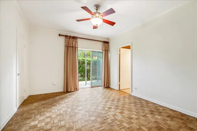 a view of a livingroom with a ceiling fan and window