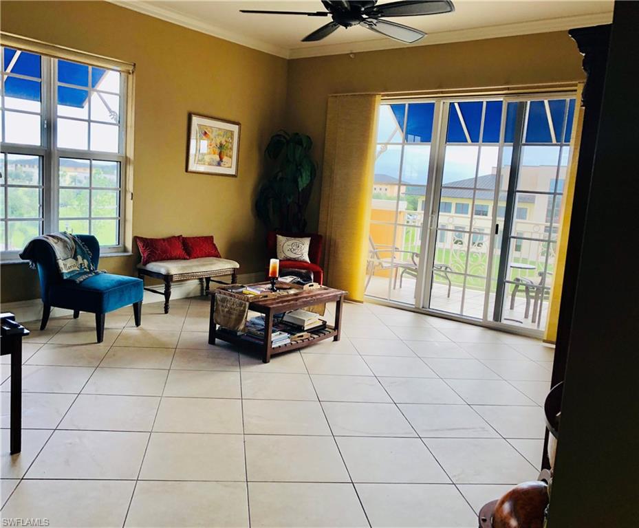 a living room with furniture and a floor to ceiling window