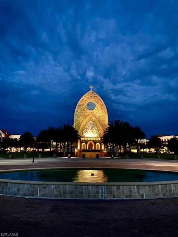 5080 Annunciation Circle, Unit 1306 Ave Maria, FL 34142 - Photo 3 of 6 a view of swimming pool with outdoor seating and lots of green space