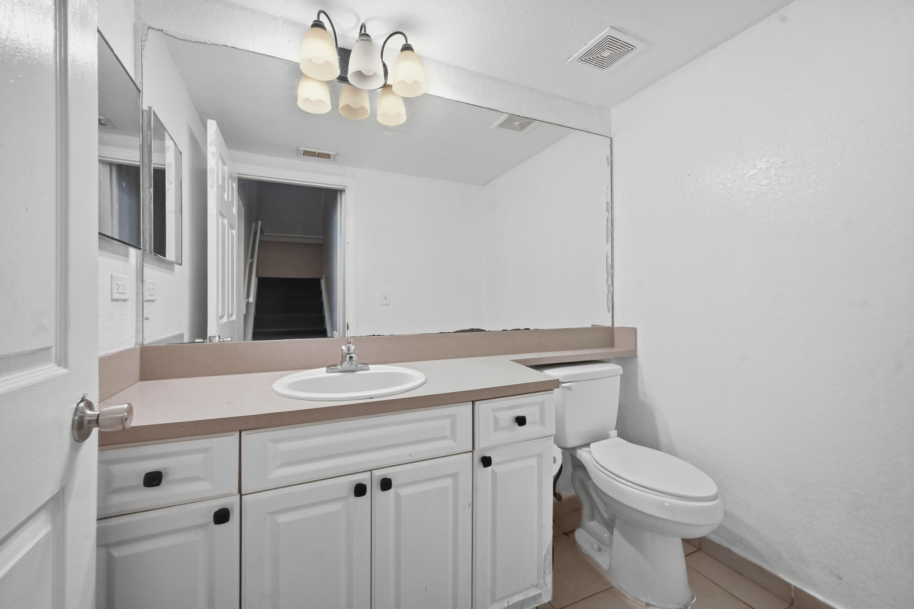 6450 West Sample Road, Unit 6450 Coral Springs, FL 33067 - Photo 14 of 41 a bathroom with a sink a toilet and a mirror