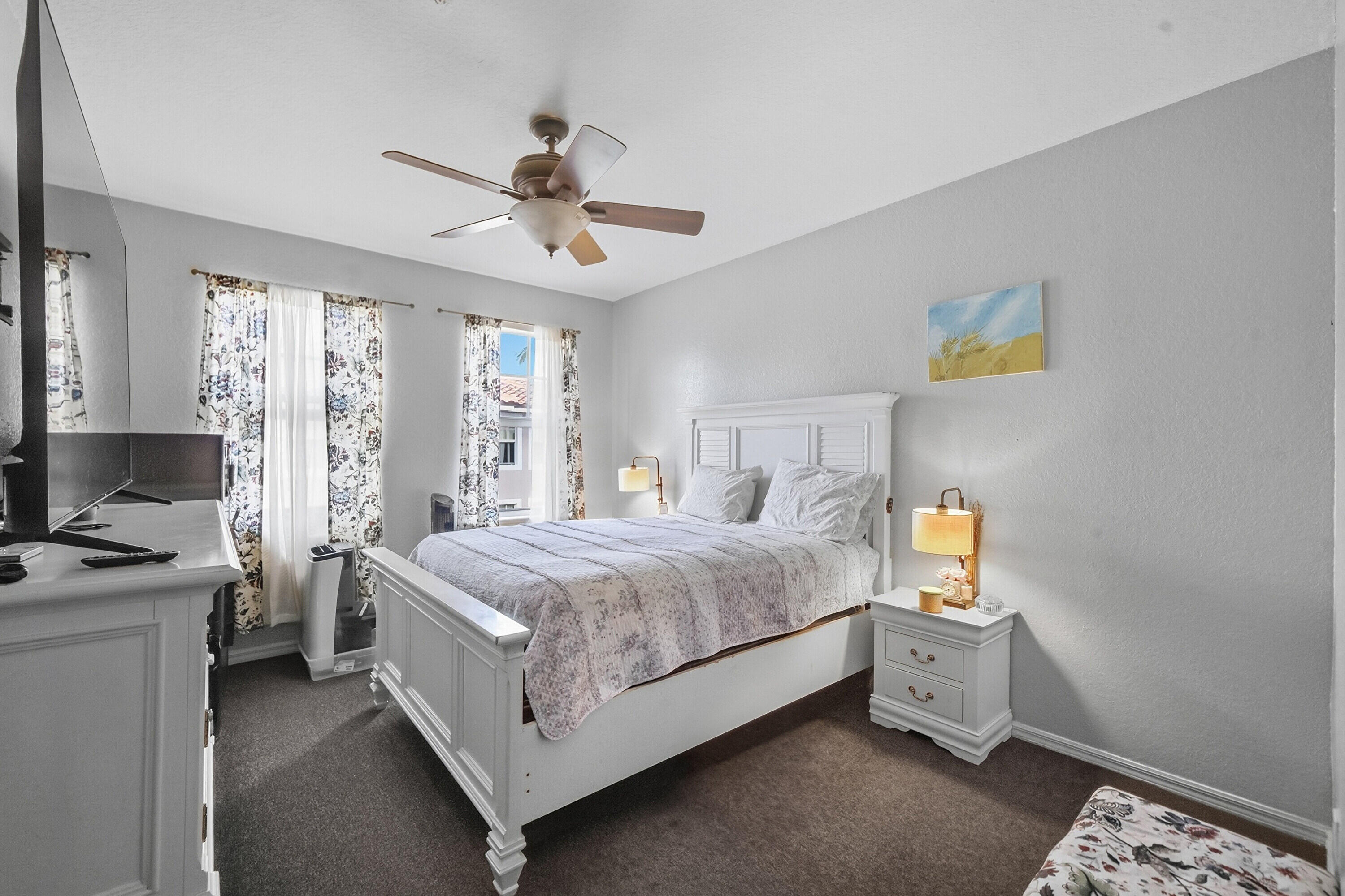 6450 West Sample Road, Unit 6450 Coral Springs, FL 33067 - Photo 19 of 41 a bedroom with a bed and a chandelier