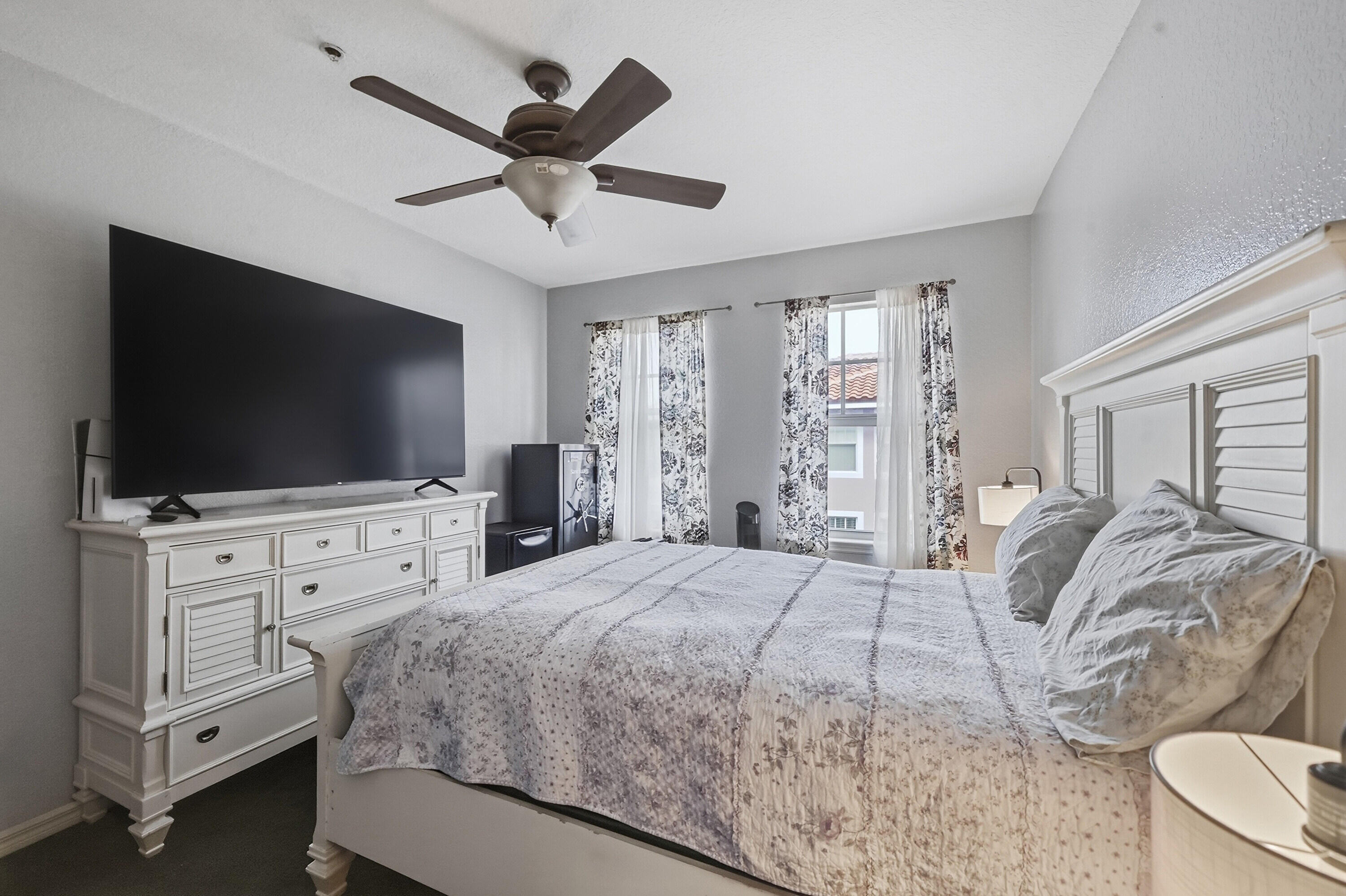 6450 West Sample Road, Unit 6450 Coral Springs, FL 33067 - Photo 20 of 41 a bedroom with a bed and a flat screen tv