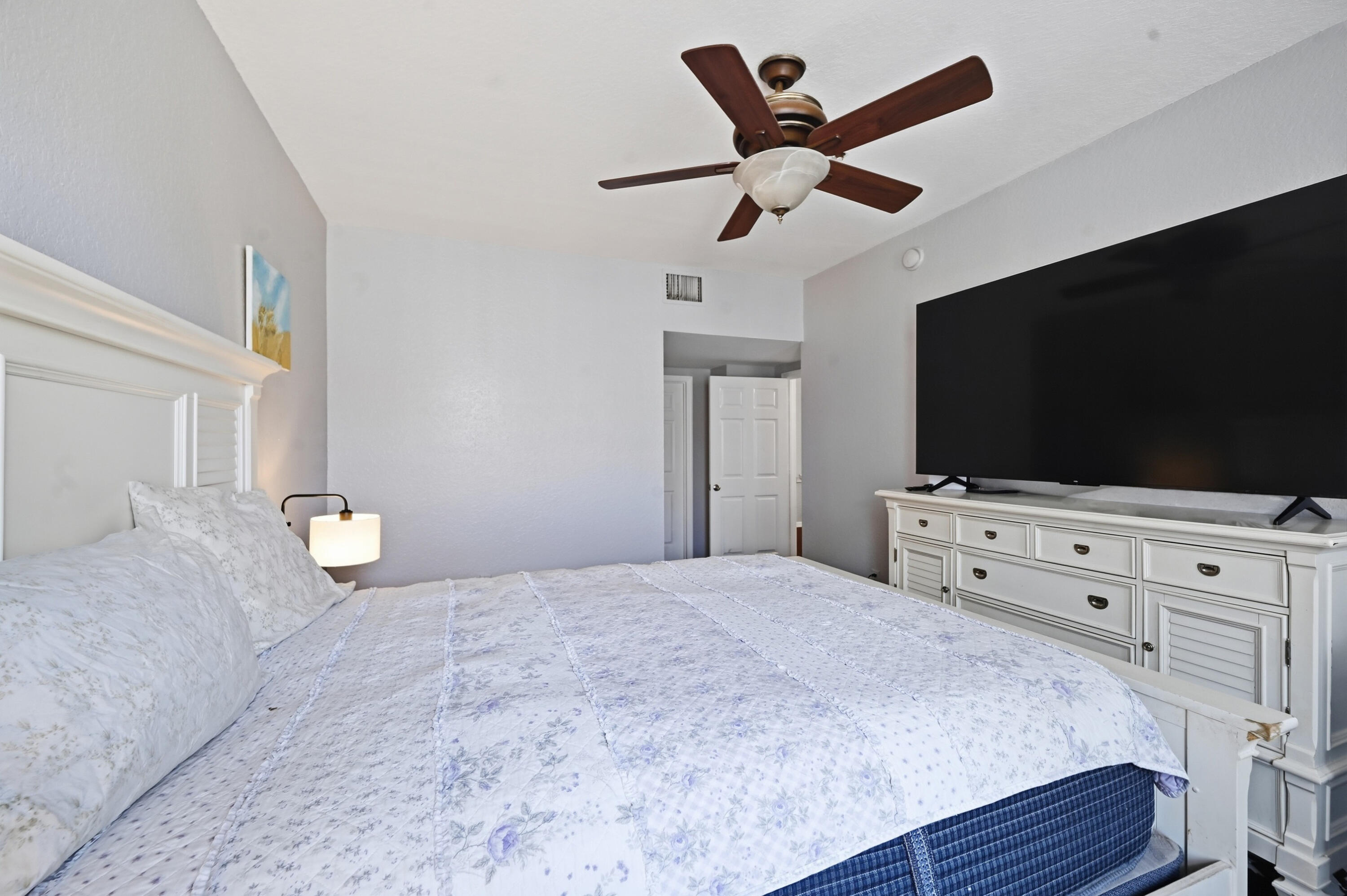 6450 West Sample Road, Unit 6450 Coral Springs, FL 33067 - Photo 21 of 41 a bedroom with a bed and a flat screen tv