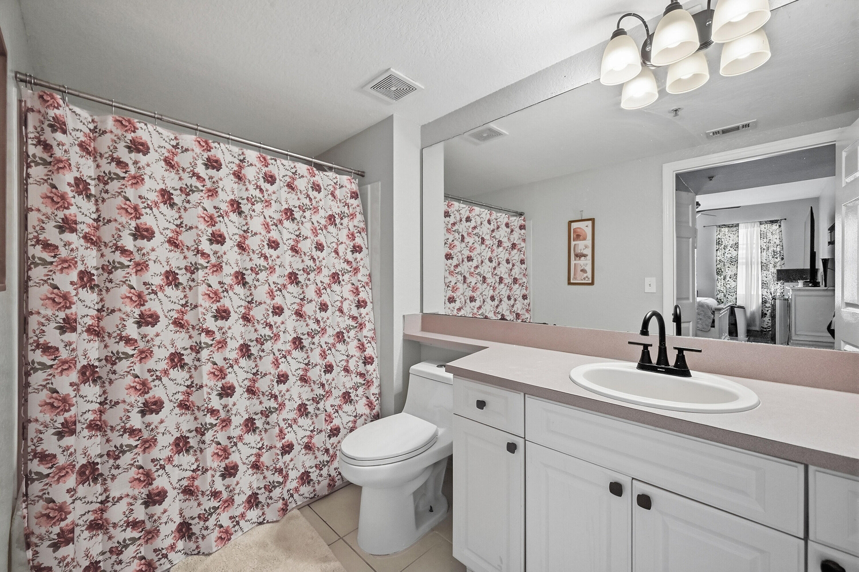 6450 West Sample Road, Unit 6450 Coral Springs, FL 33067 - Photo 23 of 41 a bathroom with a sink a toilet and a mirror