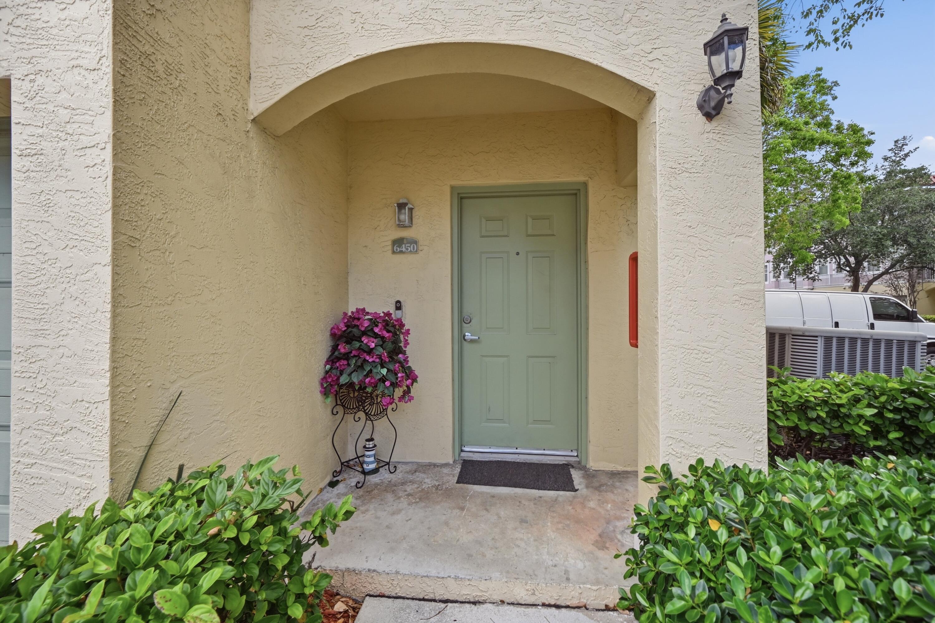 6450 West Sample Road, Unit 6450 Coral Springs, FL 33067 - Photo 3 of 41 a vase with flowers sitting on a brick wall