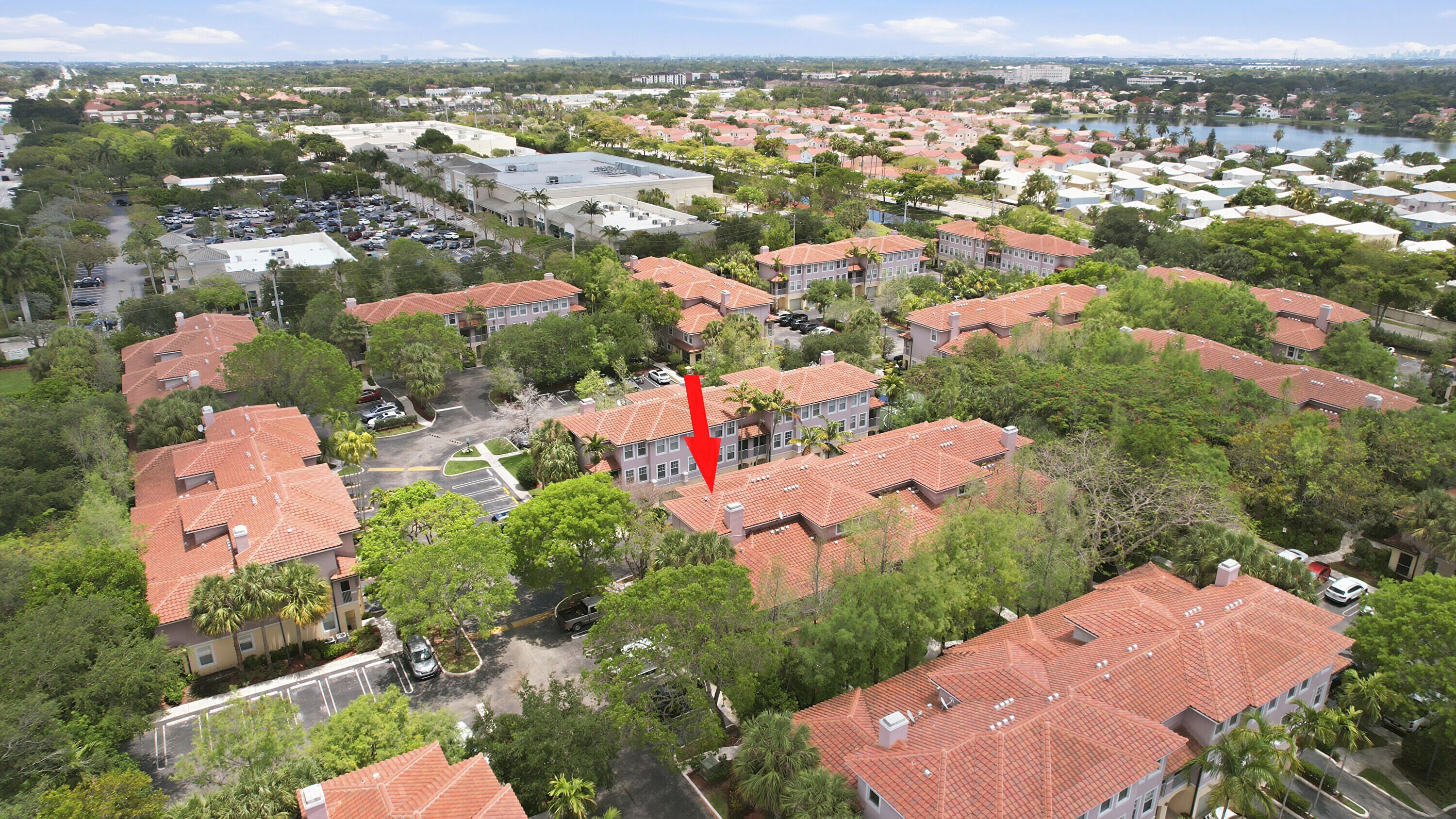 6450 West Sample Road, Unit 6450 Coral Springs, FL 33067 - Photo 35 of 41 an aerial view of a city with lots of residential buildings and mountain view in back