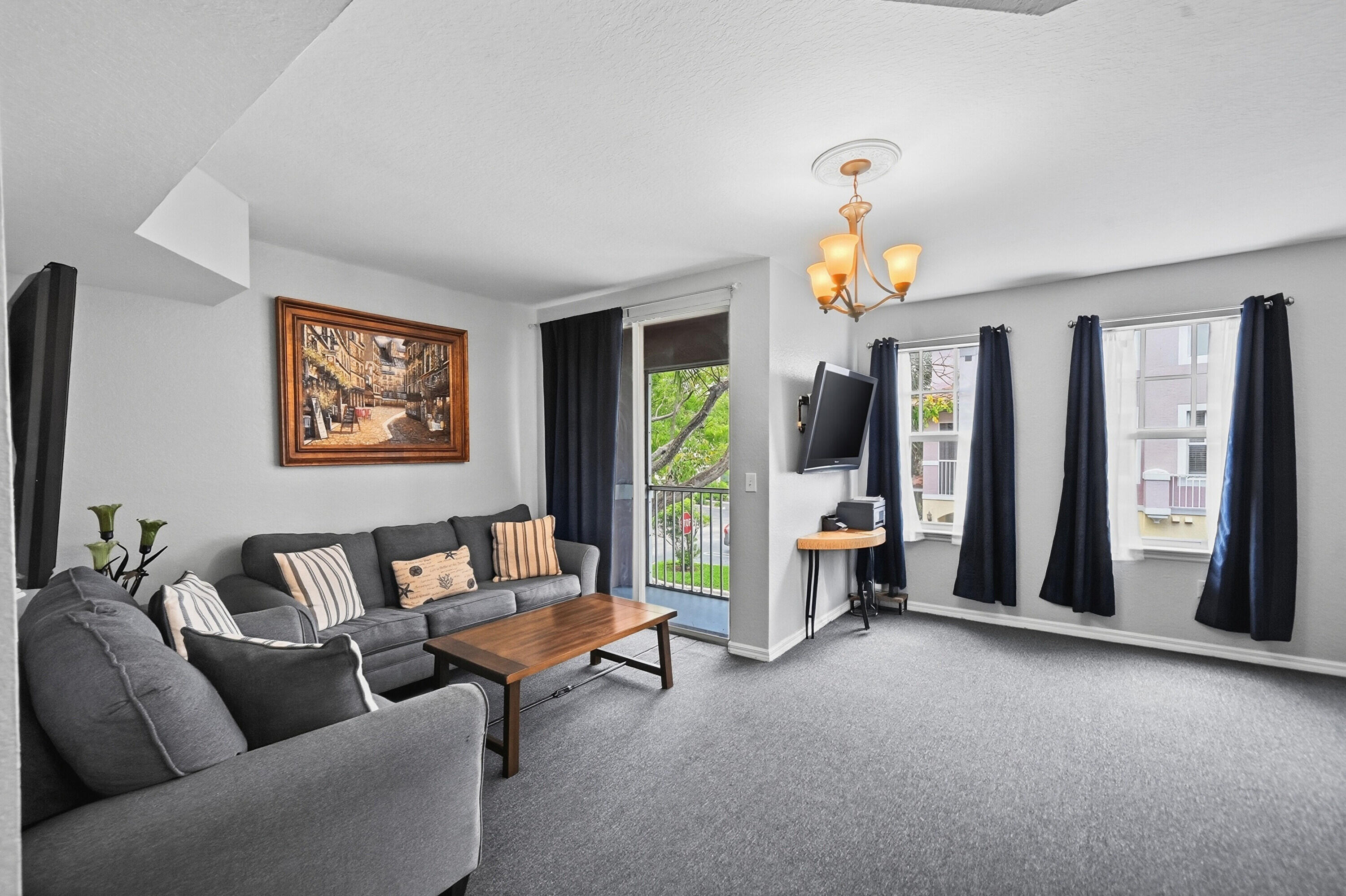 6450 West Sample Road, Unit 6450 Coral Springs, FL 33067 - Photo 5 of 41 a living room with furniture a chandelier and a window