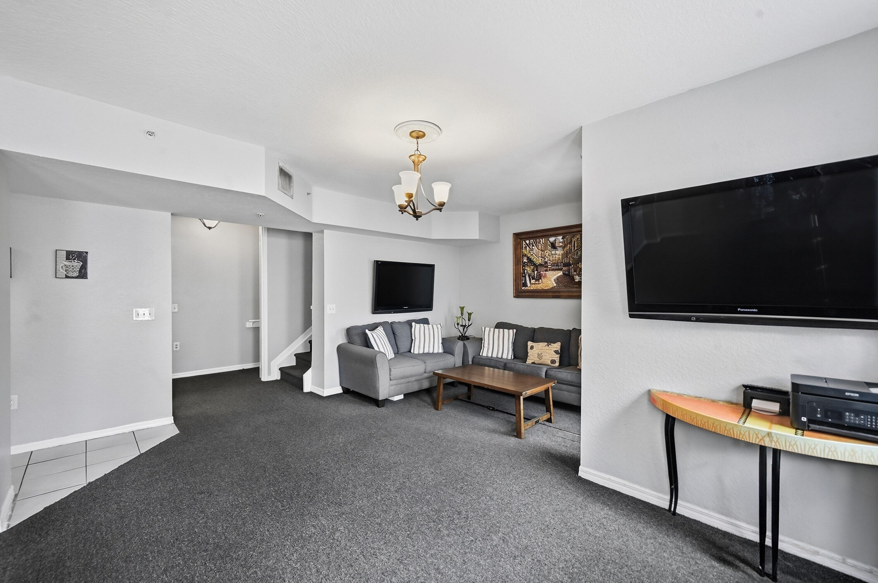 6450 West Sample Road, Unit 6450 Coral Springs, FL 33067 - Photo 7 of 41 a living room with furniture and a flat screen tv