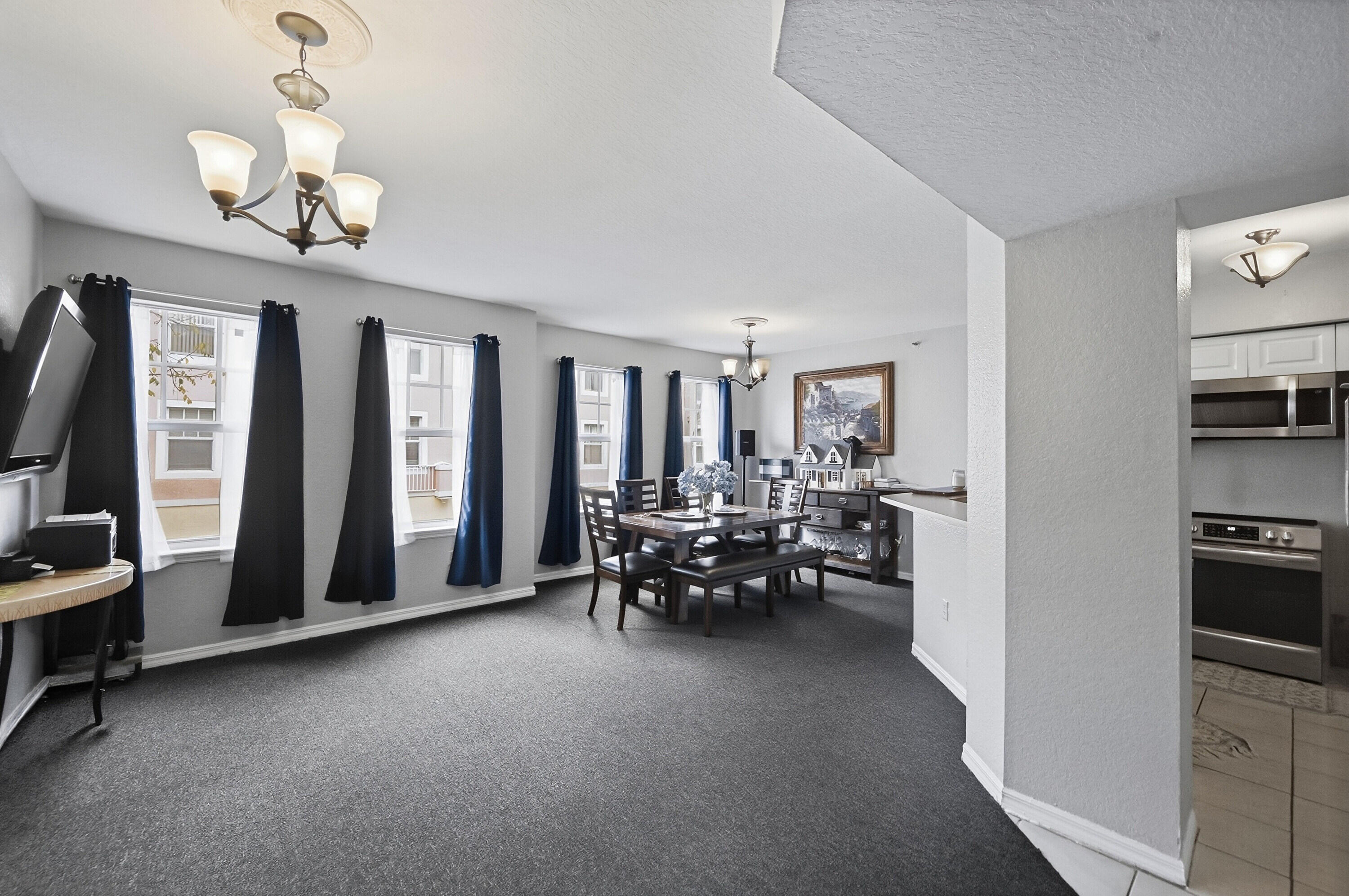 6450 West Sample Road, Unit 6450 Coral Springs, FL 33067 - Photo 8 of 41 a living room with furniture and a chandelier