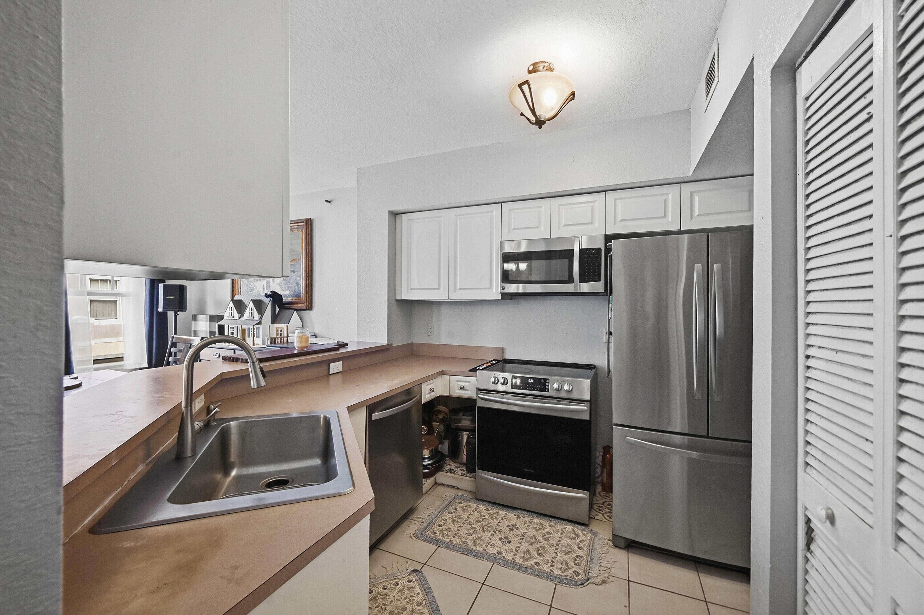 6450 West Sample Road, Unit 6450 Coral Springs, FL 33067 - Photo 10 of 41 a kitchen with a refrigerator sink and microwave
