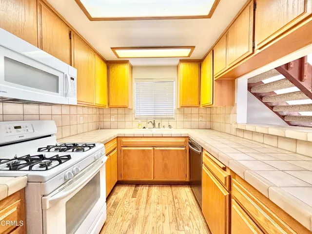 a kitchen with a stove a sink and a refrigerator
