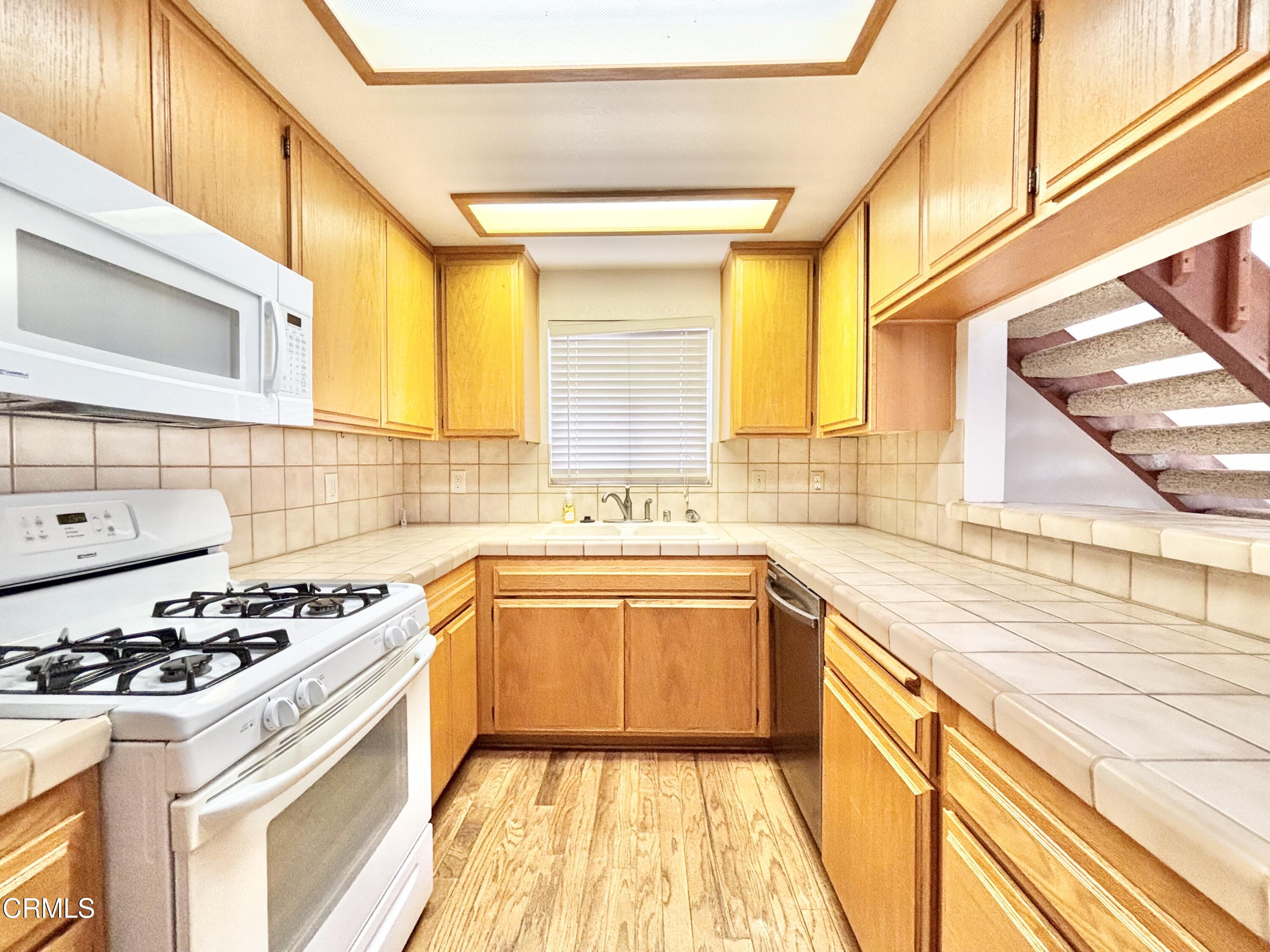 272 Cahuenga Drive Oxnard, CA 93035 - Photo 21 of 39 a kitchen with a sink a stove and a window