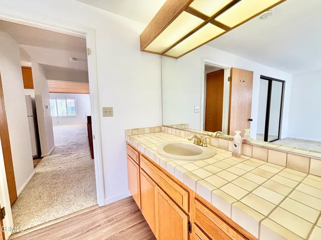 a view of a kitchen with wooden floor and a sink