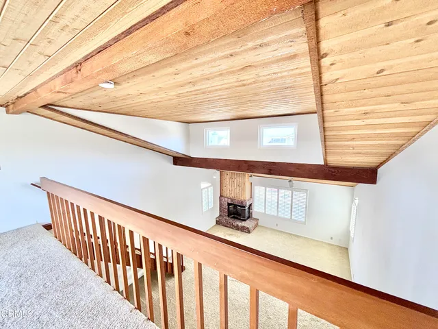 a view of staircase with railing and white walls