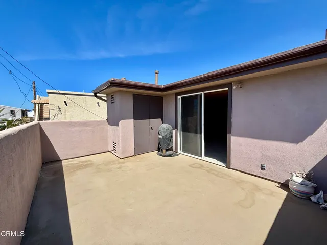 a view of a glass door and a room