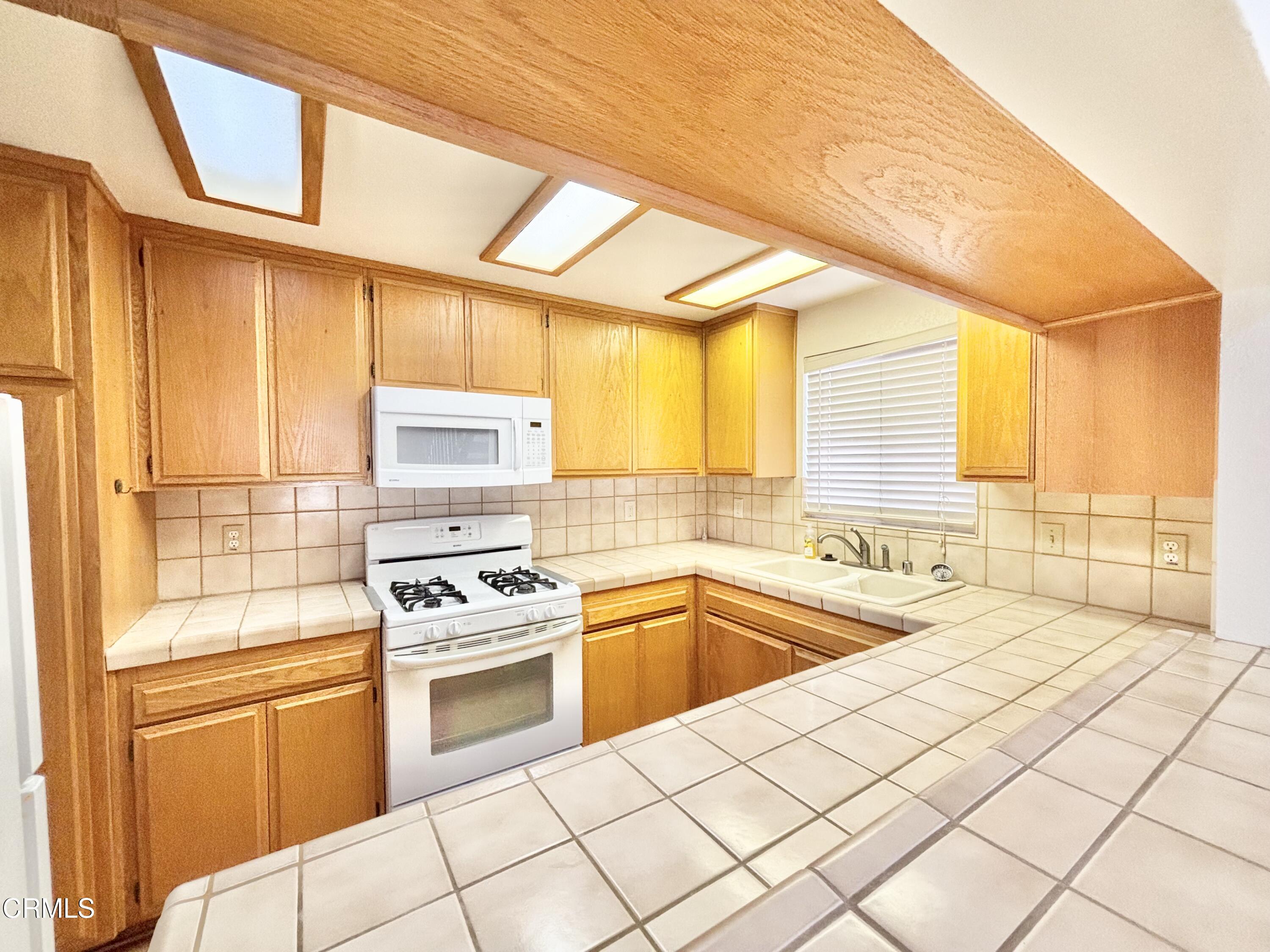 272 Cahuenga Drive Oxnard, CA 93035 - Photo 5 of 39 a kitchen with a sink a stove and cabinets