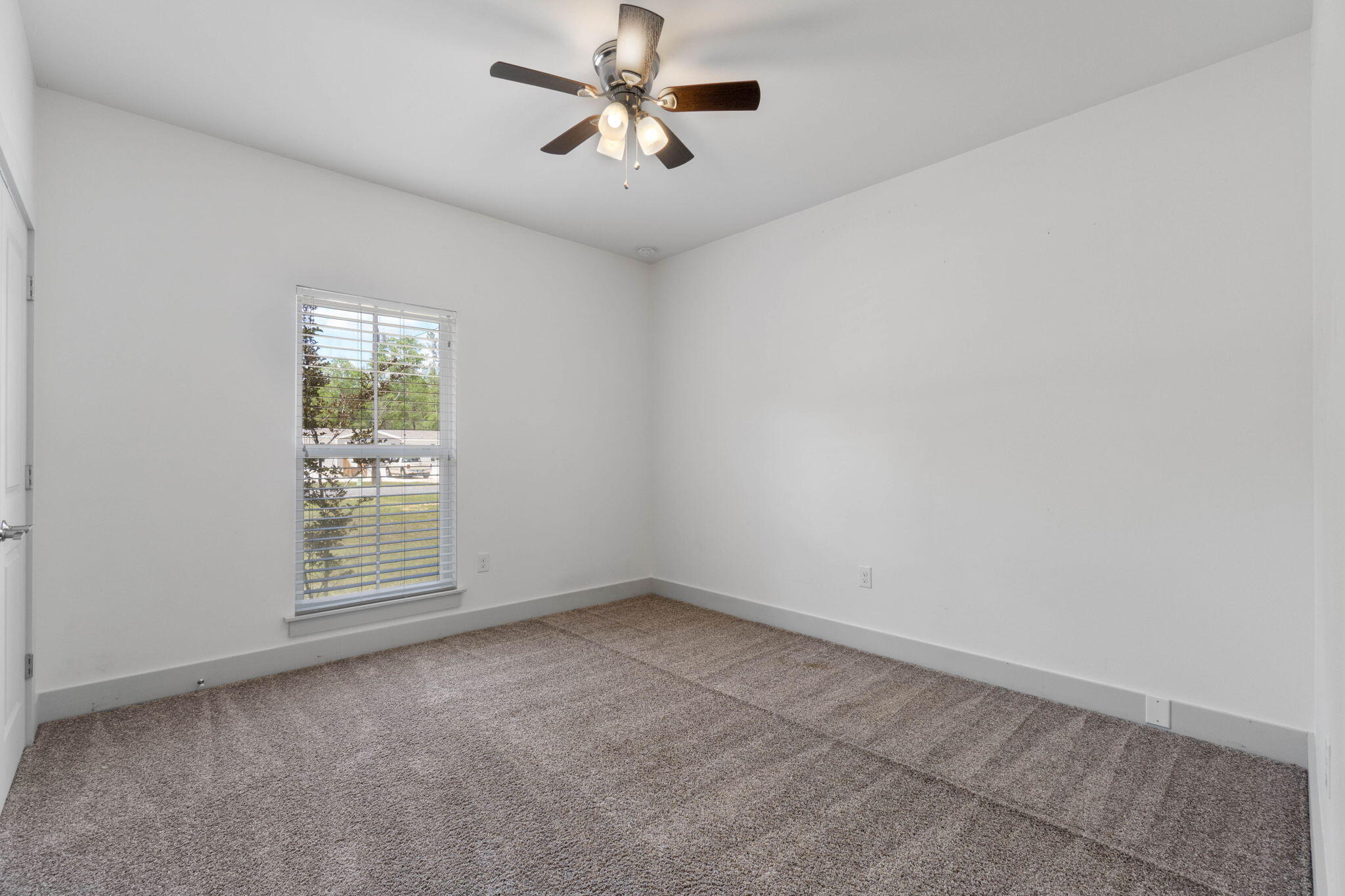 4464 Goldfinch Way Crestview, FL 32539 - Photo 12 of 31 an empty room with windows and fan