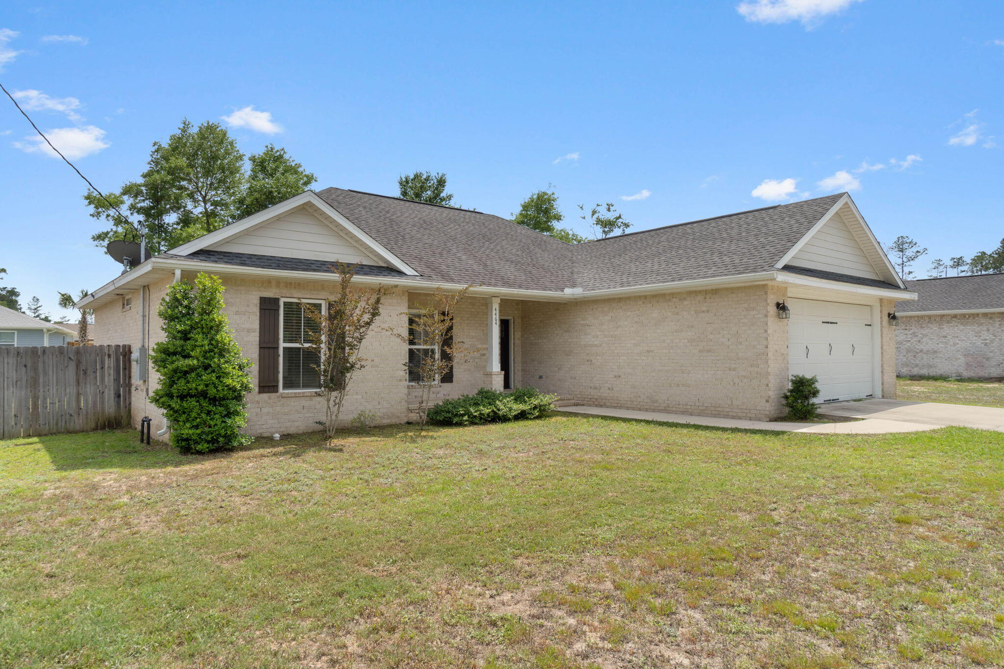 4464 Goldfinch Way Crestview, FL 32539 - Photo 2 of 31 a view of a house with a yard and garage