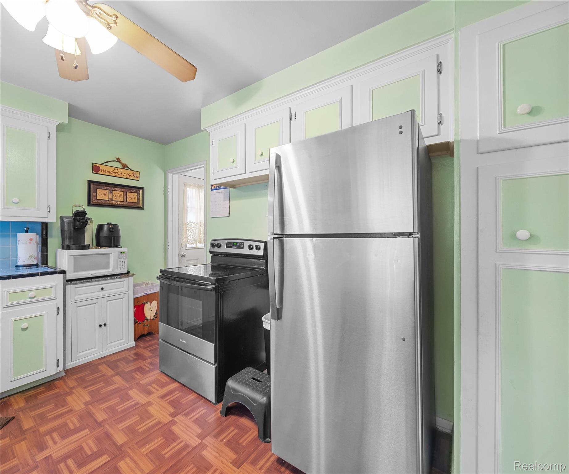 28940 Grandview Street Inkster, MI 48141 - Photo 23 of 41 Kitchen with stainless steel appliances, white cabinetry, ceiling fan, and dark countertops