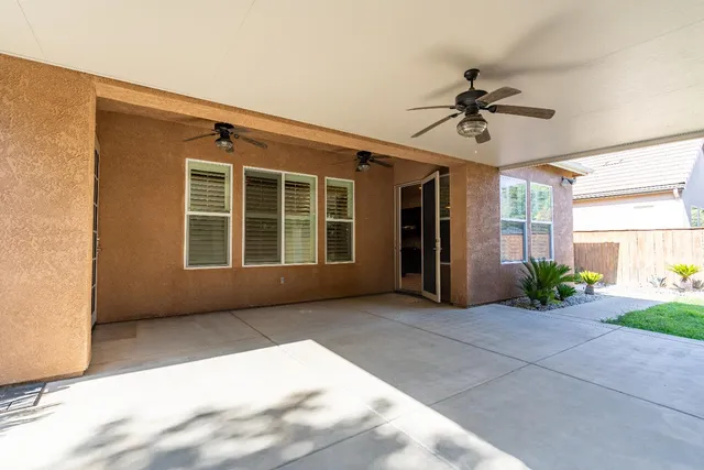 a view of an empty room with a window and a fireplace